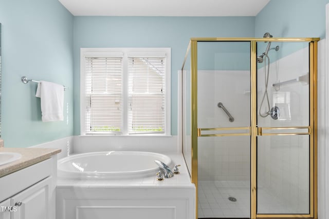 bathroom with a stall shower, vanity, and a garden tub