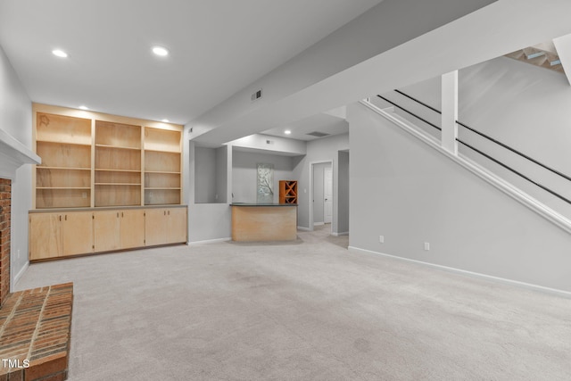 unfurnished living room featuring baseboards, light carpet, visible vents, and recessed lighting
