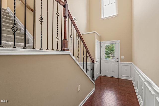 507 Brier Crossings Loop, Durham, NC 27703 - entryway featuring a wainscoted wall, stairs, hardwood / wood-style floors, and a decorative wall