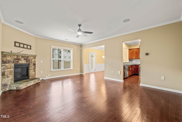 507 Brier Crossings Loop, Durham, NC 27703 - unfurnished living room featuring ornamental molding, ceiling fan, dark wood-style flooring, and a stone fireplace