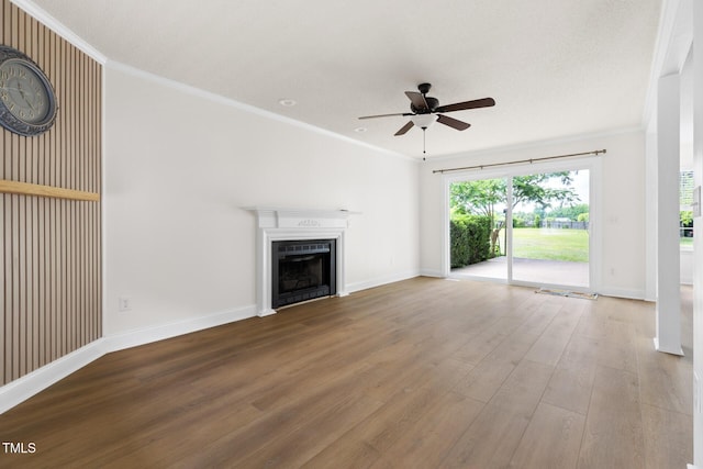 59 Troy Dr, Fuquay Varina, NC 27526 - unfurnished living room with ceiling fan, wood finished floors, a fireplace, baseboards, and crown molding