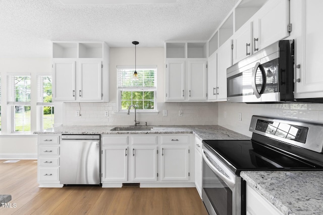 59 Troy Dr, Fuquay Varina, NC 27526 - kitchen with stainless steel appliances, a sink, white cabinets, and a textured ceiling