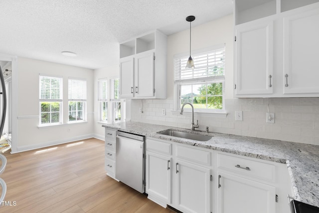 59 Troy Dr, Fuquay Varina, NC 27526 - kitchen featuring stainless steel dishwasher, a sink, white cabinetry, decorative backsplash, and a textured ceiling