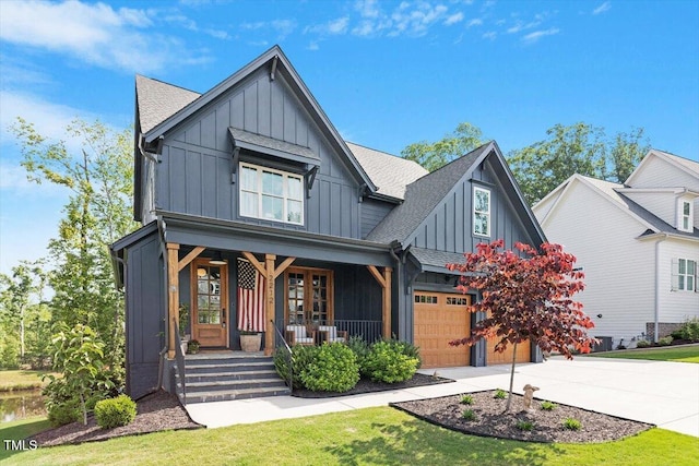 view of front of home featuring board and batten siding, covered porch, concrete driveway, and a shingled roof