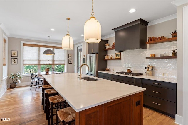 kitchen featuring open shelves, stainless steel appliances, light countertops, decorative backsplash, and light wood finished floors