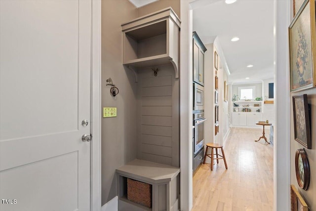 mudroom with light wood finished floors and recessed lighting