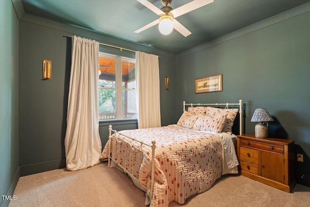 bedroom with light carpet, a ceiling fan, and baseboards