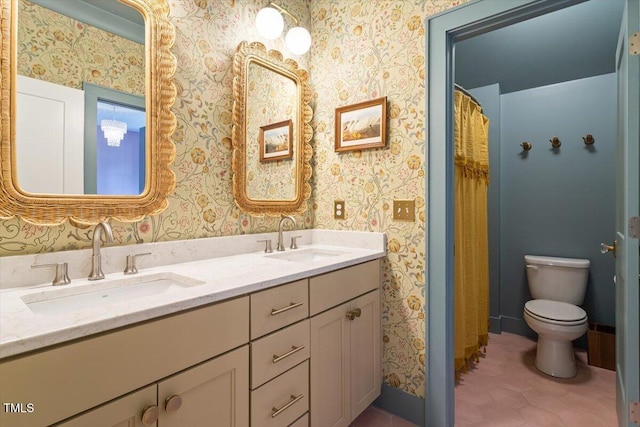 full bath with wallpapered walls, toilet, double vanity, and tile patterned flooring