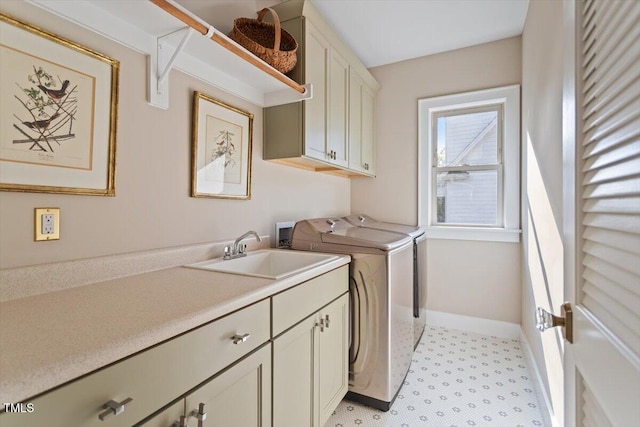 washroom featuring cabinet space, independent washer and dryer, and baseboards