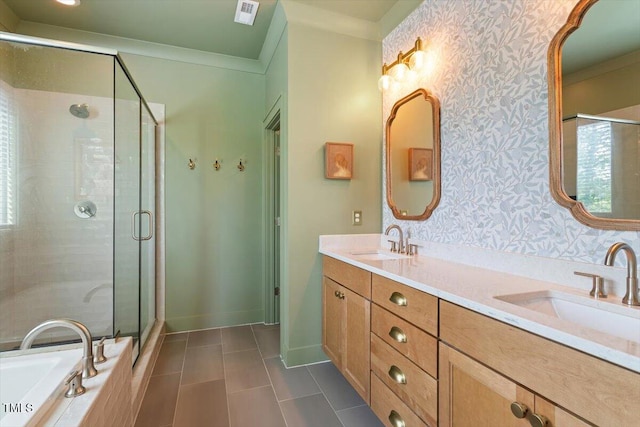 full bath featuring wallpapered walls, a shower stall, tile patterned flooring, double vanity, and ornamental molding