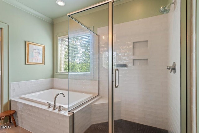 full bathroom featuring a bath and a shower stall