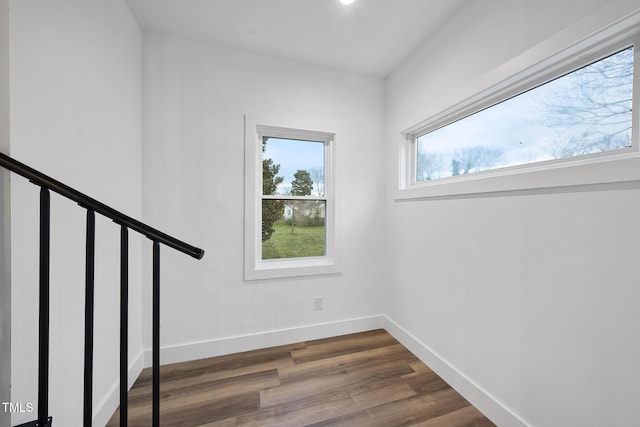 staircase with wood finished floors and baseboards