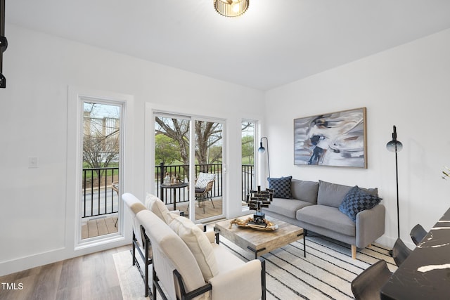 living room with light wood-type flooring and baseboards