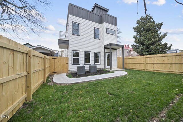rear view of property featuring central AC