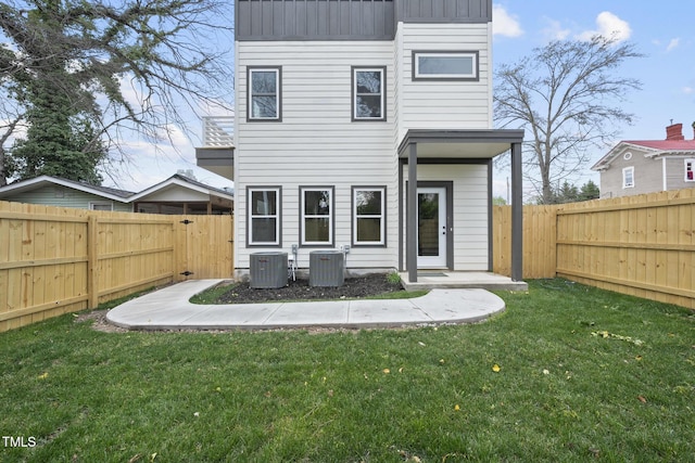 rear view of property with cooling unit and a gate