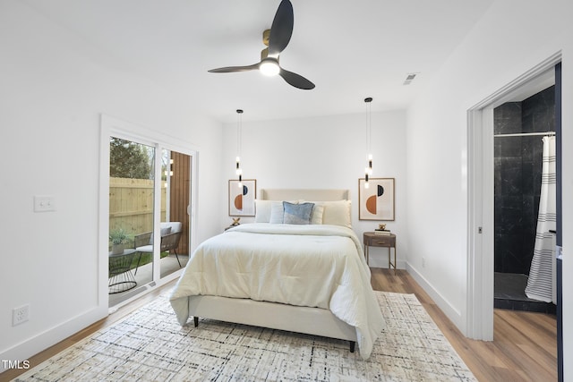 bedroom featuring light wood finished floors, baseboards, and access to exterior