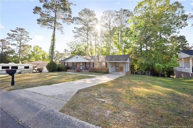 ranch-style home with driveway, a front yard, and a carport