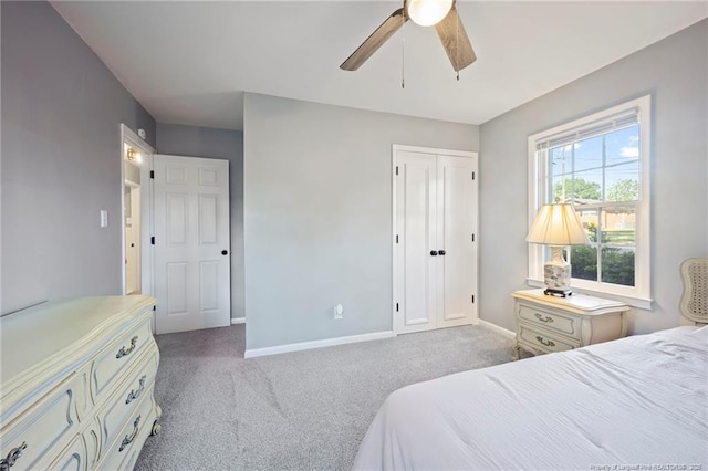 bedroom featuring baseboards, a closet, a ceiling fan, and carpet