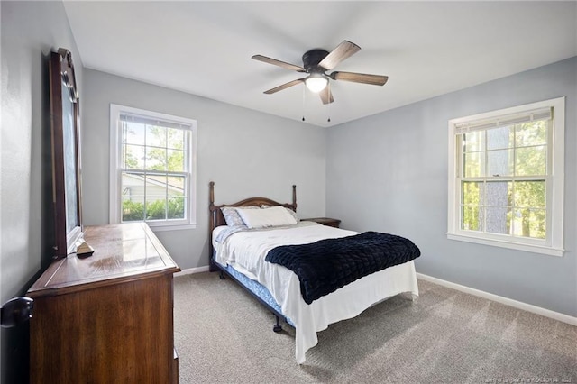 carpeted bedroom with baseboards and a ceiling fan