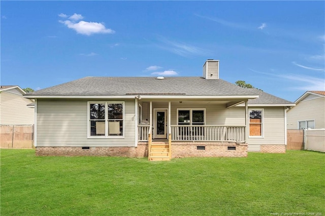 back of house with a lawn, covered porch, fence, and crawl space