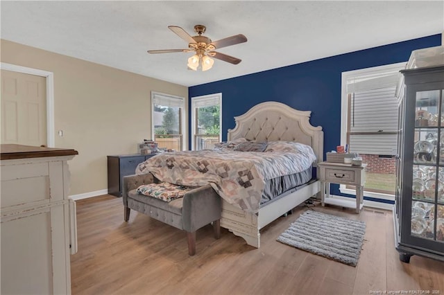 bedroom featuring a ceiling fan, wood finished floors, and baseboards