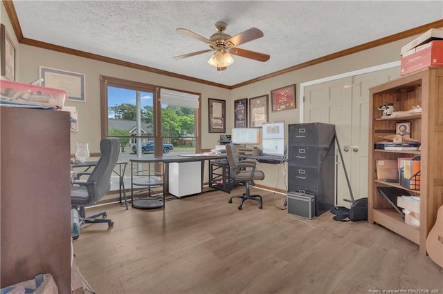 office space featuring ceiling fan, a textured ceiling, ornamental molding, and wood finished floors