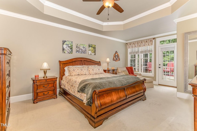 bedroom with a tray ceiling, light colored carpet, access to outside, crown molding, and baseboards