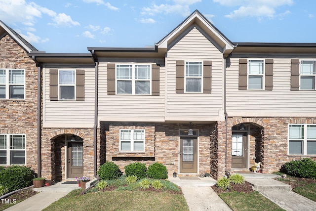 townhome / multi-family property with stone siding