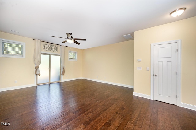 unfurnished room with a ceiling fan, dark wood-style flooring, and baseboards