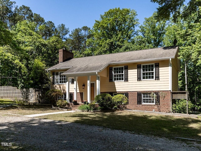 split foyer home featuring a chimney and brick siding