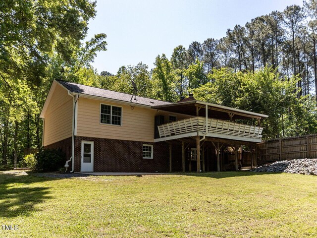 rear view of property with brick siding and a deck