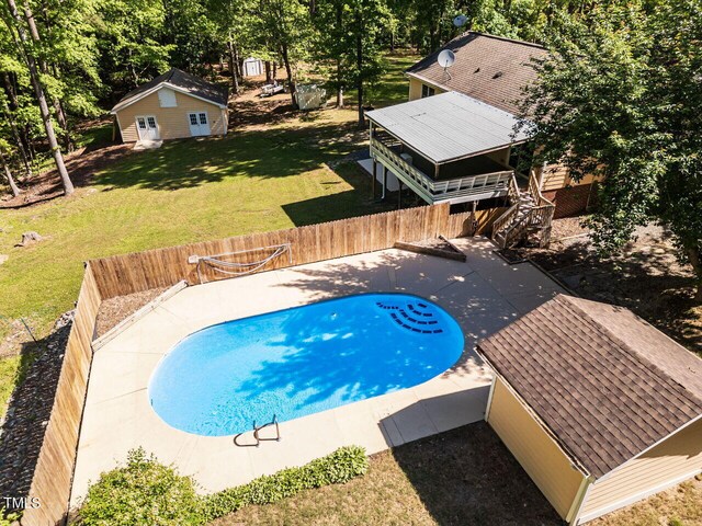 view of swimming pool featuring stairs, a patio area, and a wooden deck