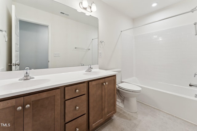 bathroom featuring toilet, double vanity, tile patterned floors, and shower / washtub combination