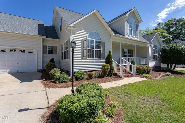 traditional-style house featuring crawl space, covered porch, driveway, a garage, and a front lawn