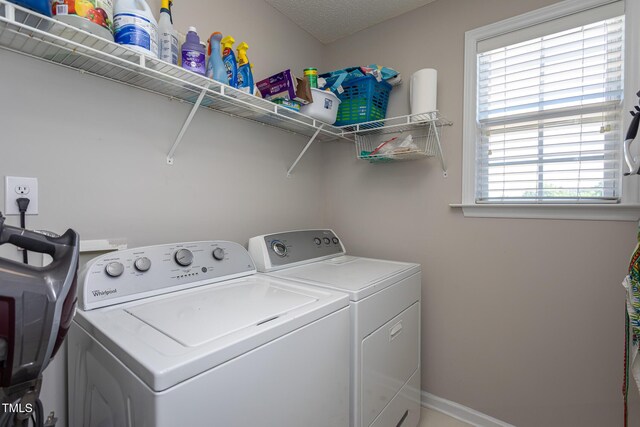laundry area featuring washing machine and clothes dryer and baseboards