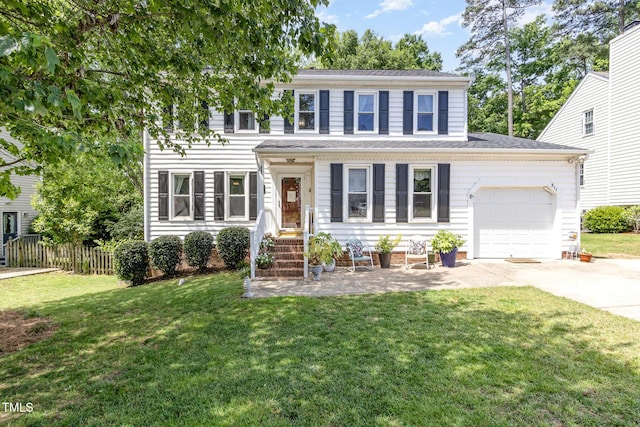colonial house featuring concrete driveway and a garage