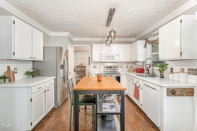 kitchen with stainless steel appliances, a sink, dark wood-style floors, backsplash, and ornamental molding