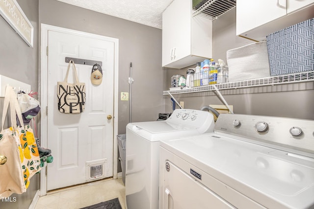 washroom with washer and clothes dryer, cabinet space, and light tile patterned floors
