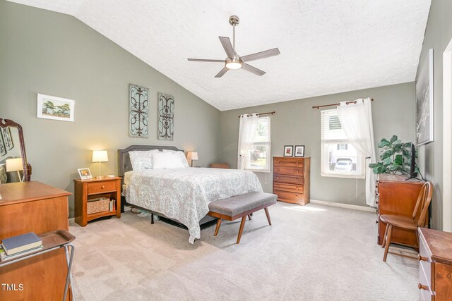 bedroom featuring vaulted ceiling, light colored carpet, a textured ceiling, baseboards, and a ceiling fan