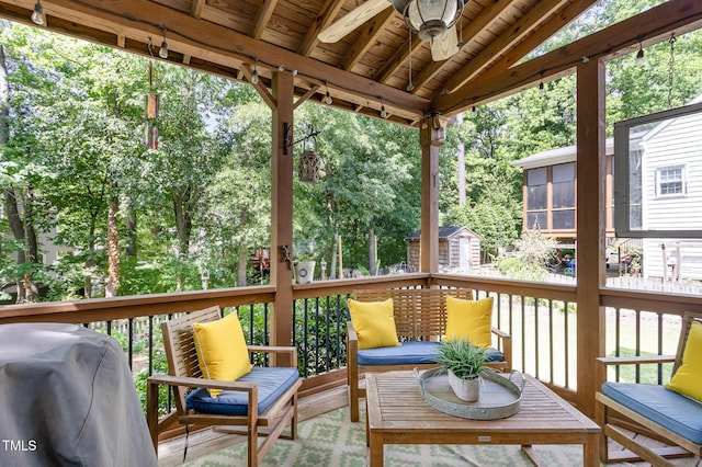 sunroom with ceiling fan and vaulted ceiling