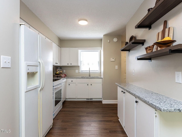 kitchen featuring white appliances, open shelves, a sink, dark wood-style flooring, and white cabinetry