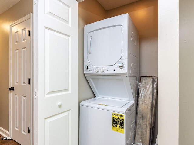 laundry area featuring stacked washer / dryer