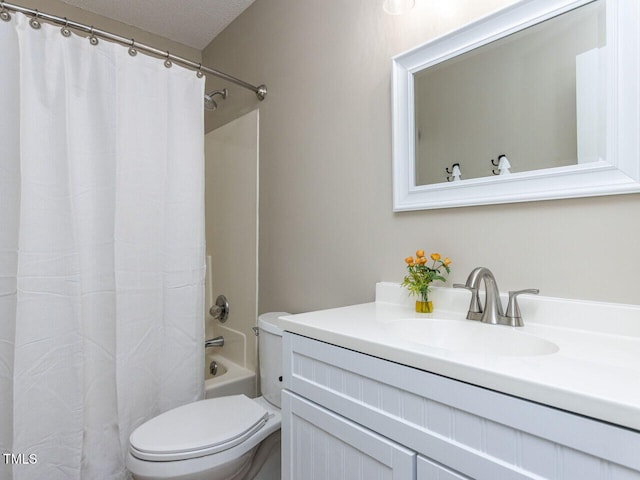 bathroom featuring toilet, vanity, and shower / tub combo