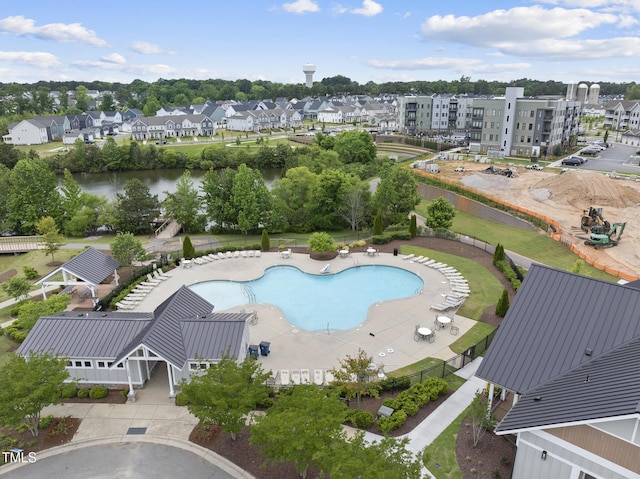 aerial perspective of suburban area featuring a pool area