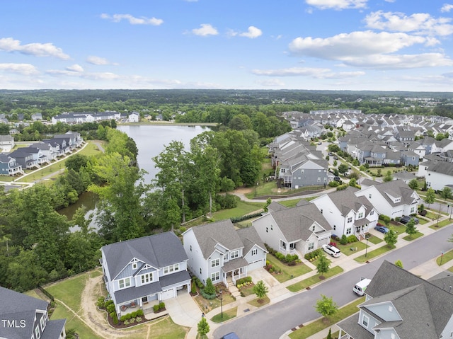 aerial view of residential area featuring a large body of water