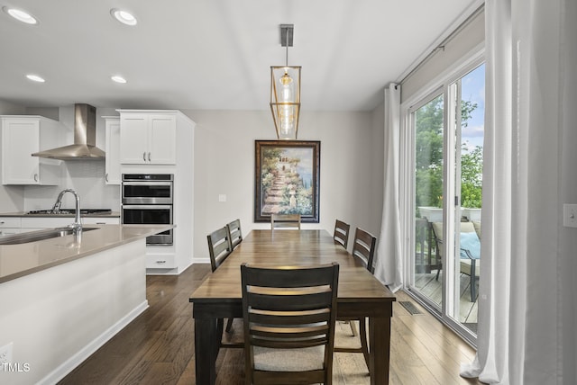 dining area featuring dark wood-type flooring, recessed lighting, and baseboards
