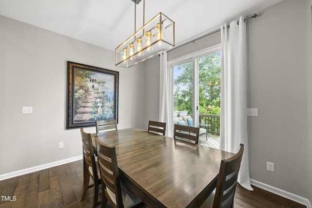 dining space with a chandelier, dark wood-style flooring, and baseboards