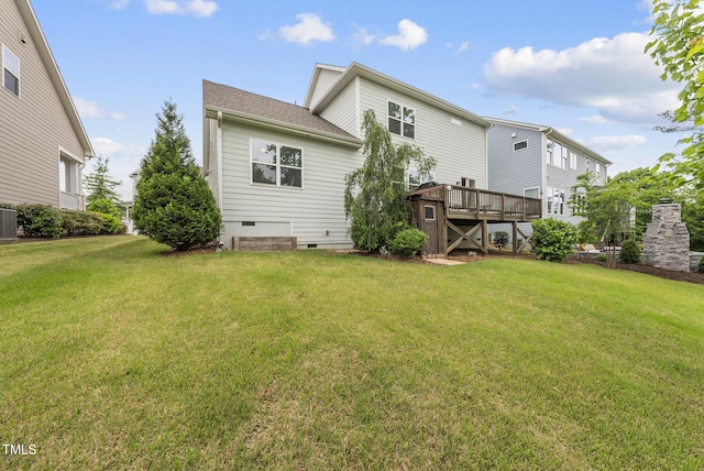 rear view of property with crawl space, a lawn, a wooden deck, and central AC unit