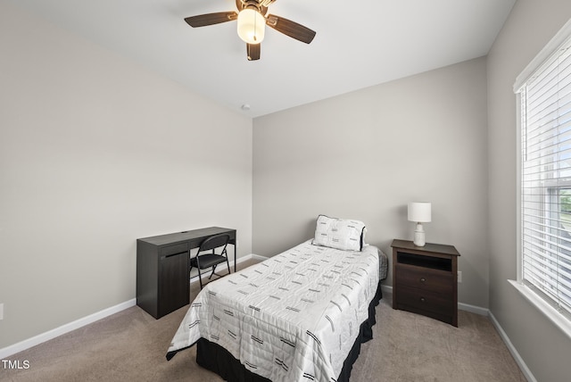 carpeted bedroom featuring baseboards and ceiling fan