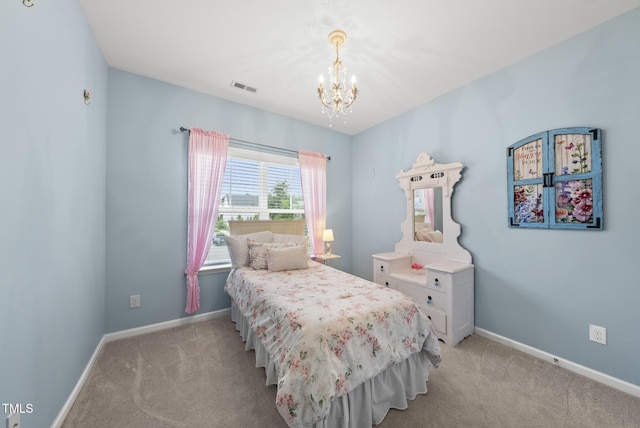 bedroom featuring a chandelier, light carpet, and baseboards